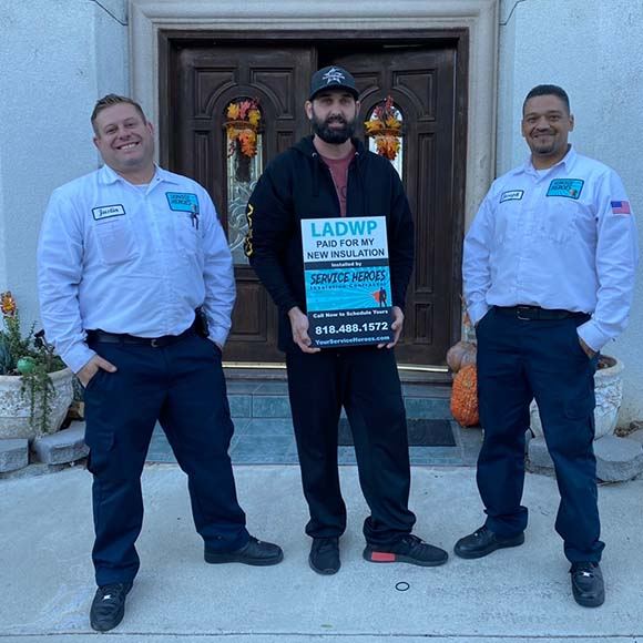 two workers with a customer holding up a paper